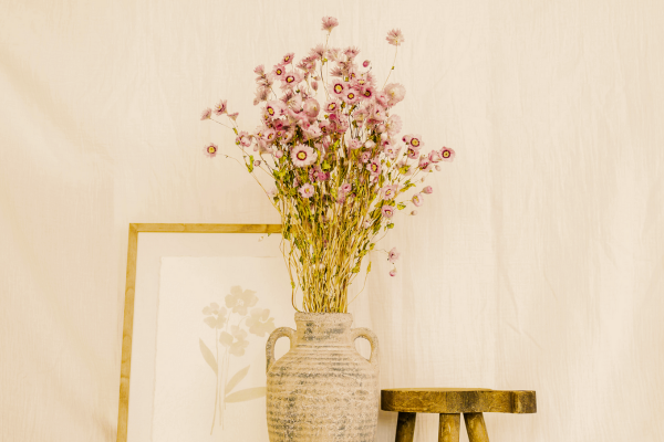 dried stems in a large vase in pink flowers