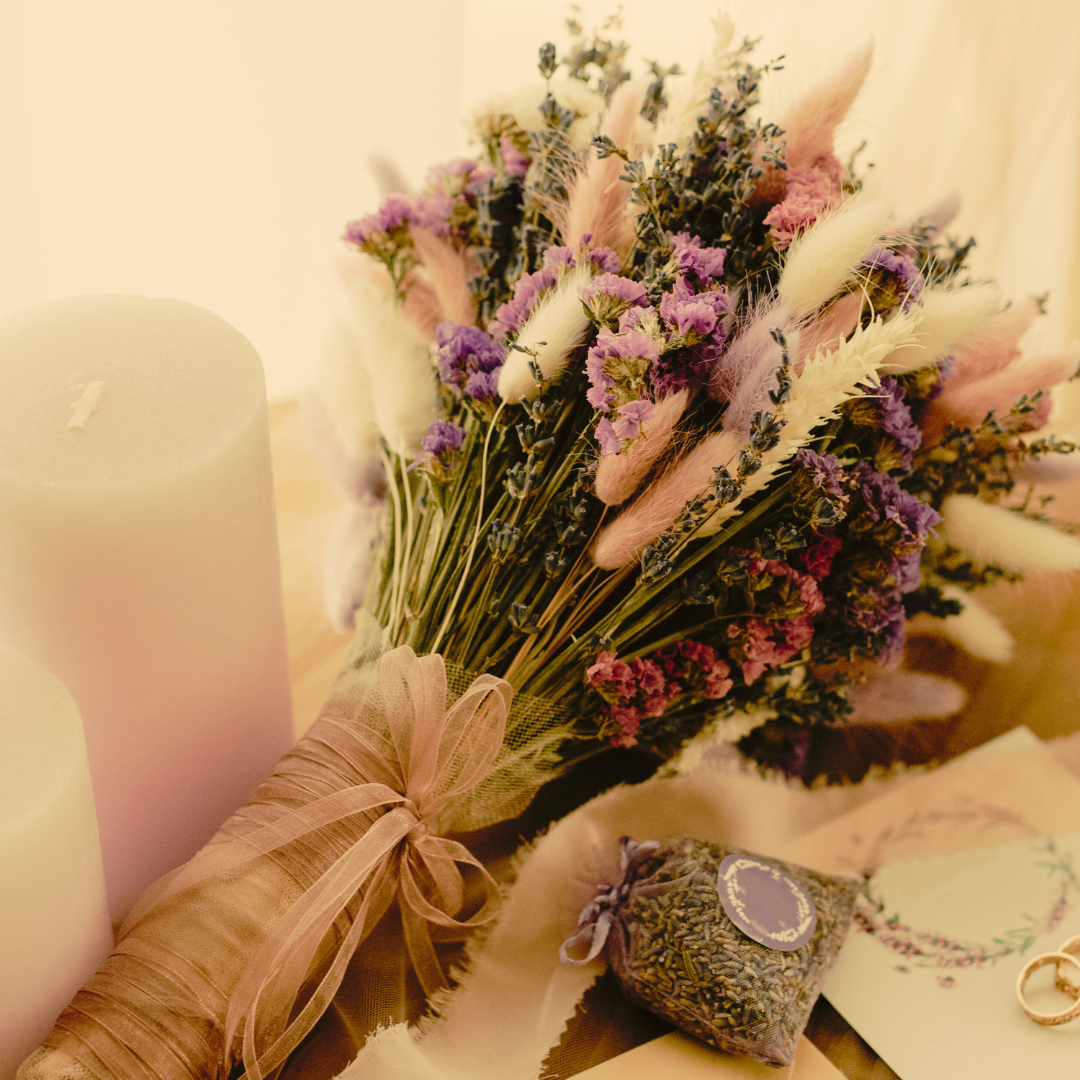 A bunch of dried flower bundles with purple dried flowers in the theme